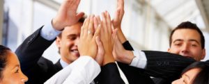 A group of business professionals exchaning a group high-five