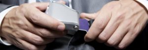 A business professional fastening a seat belt around his waist