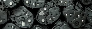 a pile of used toner cartridges