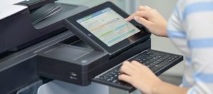 A woman's hands using a printer touchscreen