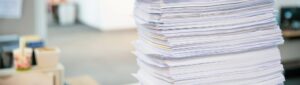 a large stack of papers on a desk
