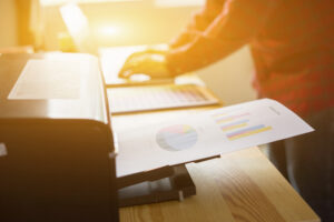 Businessman analyzing investment charts and business plan with printer. Accounting,Business People Planning Strategy Analysis Office print concept,vintage color