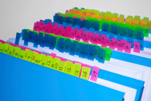 Colorful, organized folders with numbered tabs, representing the need for an efficient document management system.