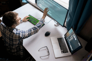 Overhead view of a cybersecurity expert assessing code